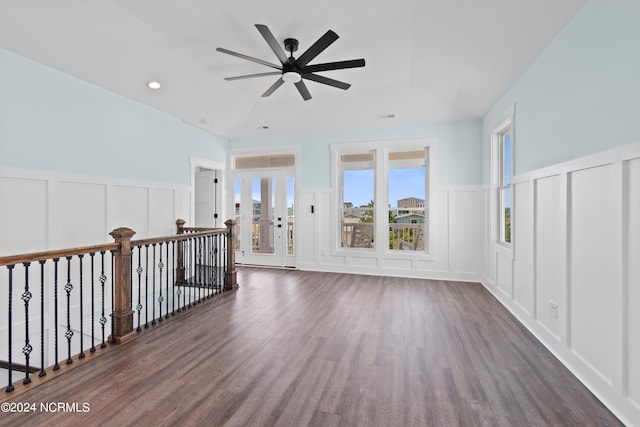 empty room with ceiling fan and dark hardwood / wood-style floors