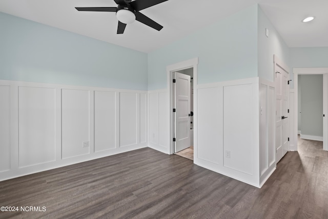 empty room with dark hardwood / wood-style flooring and ceiling fan