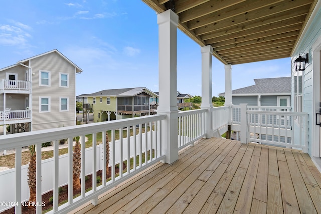 wooden terrace with a gazebo and a sunroom