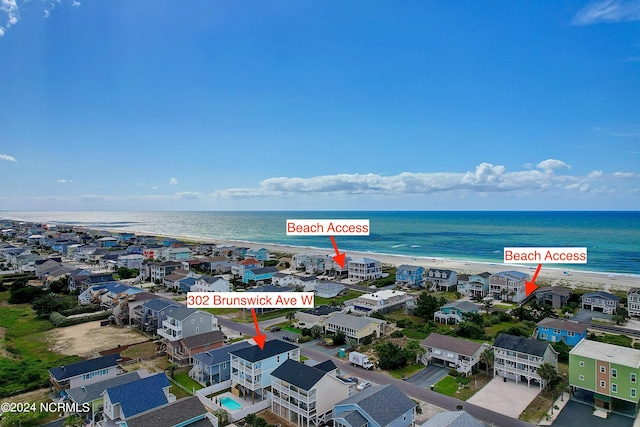 drone / aerial view with a beach view and a water view