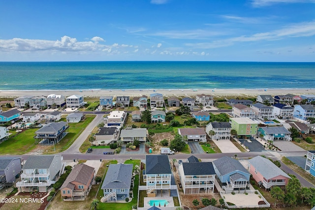 bird's eye view with a water view and a beach view