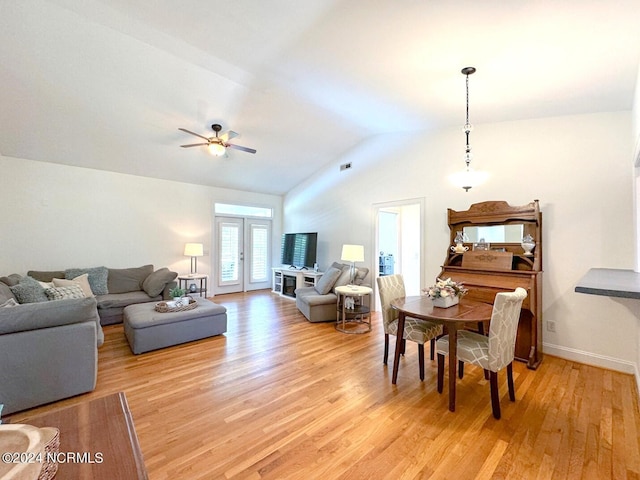 dining space with light hardwood / wood-style floors, ceiling fan, french doors, and lofted ceiling