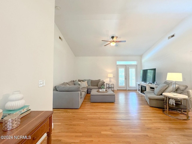 living room featuring ceiling fan, french doors, and light wood-type flooring