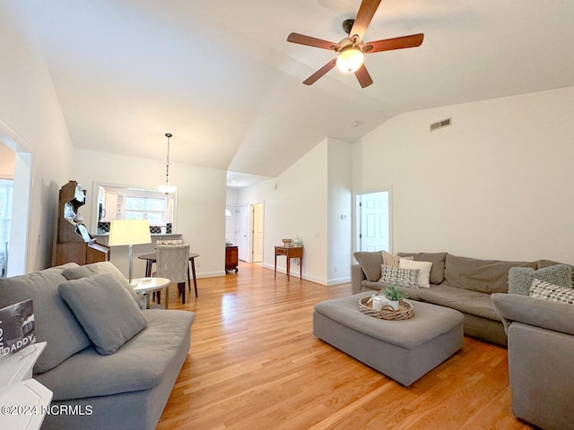 living room featuring lofted ceiling, ceiling fan, and light hardwood / wood-style floors