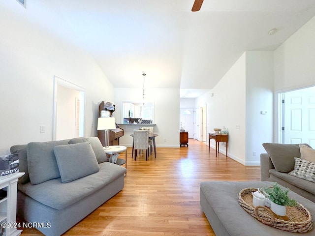 living room with ceiling fan and light hardwood / wood-style flooring