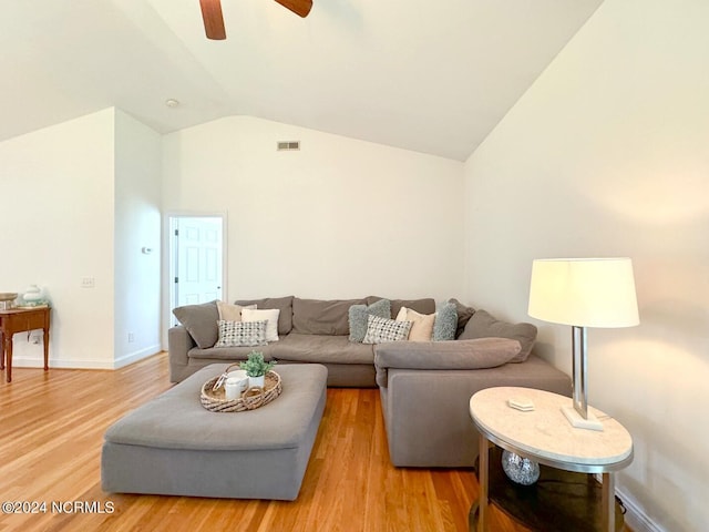 living room featuring light hardwood / wood-style floors, ceiling fan, and vaulted ceiling