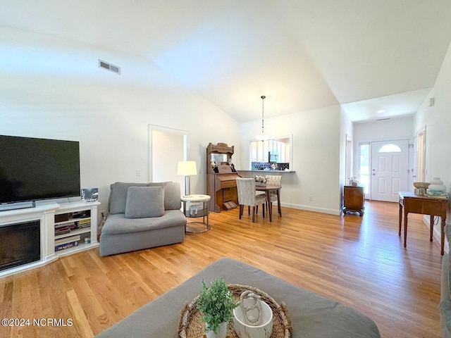 living room featuring vaulted ceiling and hardwood / wood-style floors