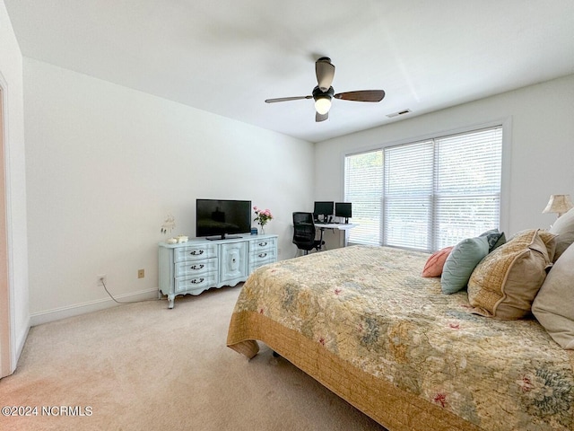 bedroom with ceiling fan and light carpet