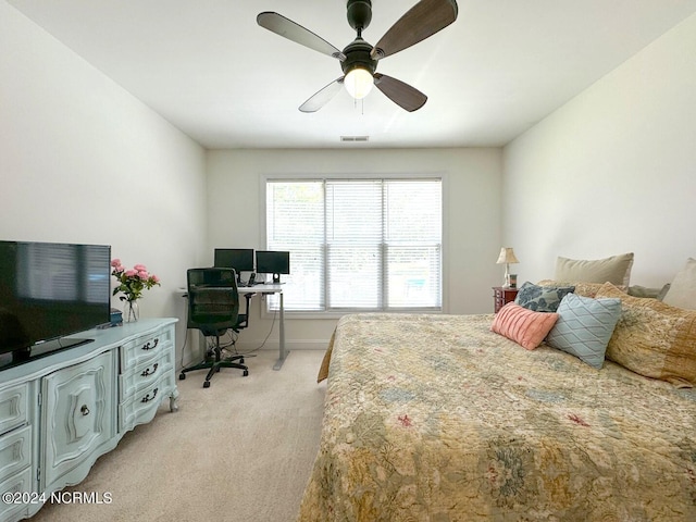 bedroom with light carpet and ceiling fan