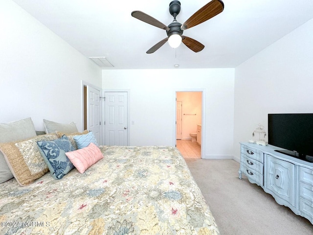 carpeted bedroom with ceiling fan and connected bathroom