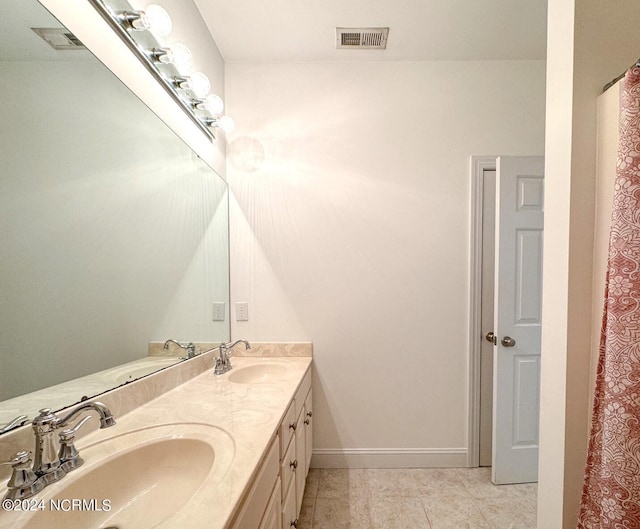 bathroom with vanity and tile patterned floors