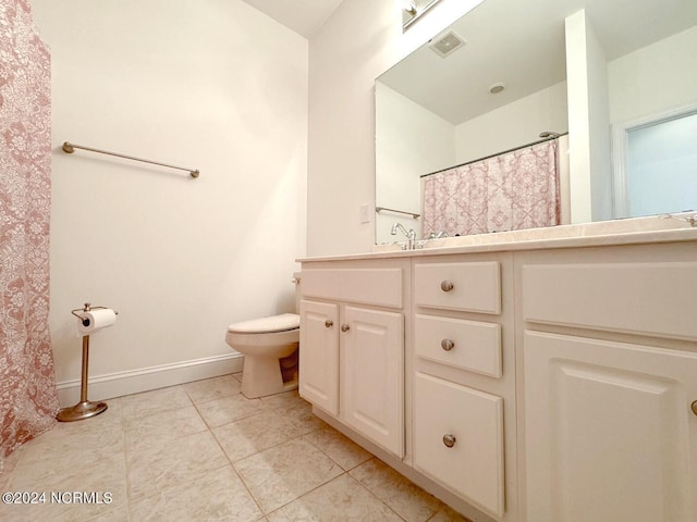 bathroom with toilet, tile patterned floors, and vanity