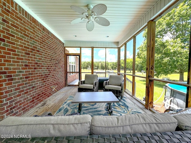 sunroom featuring ceiling fan