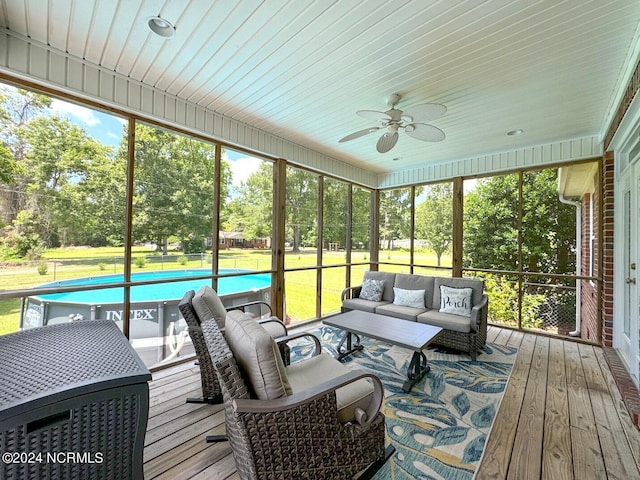 sunroom / solarium featuring ceiling fan