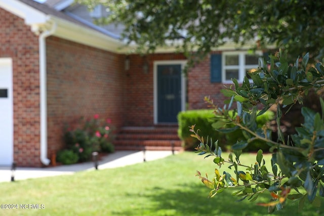 doorway to property with a yard