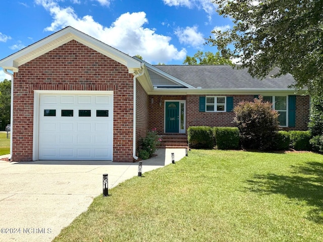 ranch-style house featuring a front yard and a garage