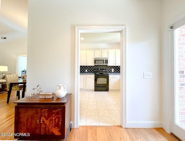 corridor with light hardwood / wood-style flooring