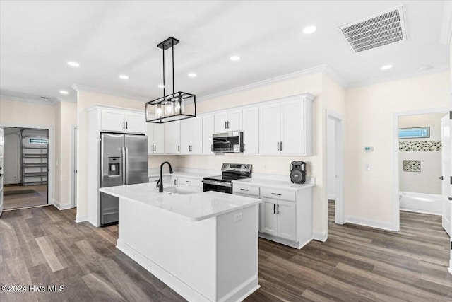 kitchen with visible vents, an island with sink, stainless steel appliances, white cabinetry, and a sink