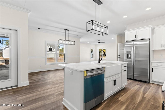 kitchen with appliances with stainless steel finishes, a sink, and white cabinets