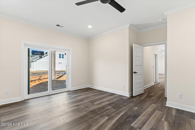 empty room with dark wood-style floors, visible vents, and crown molding