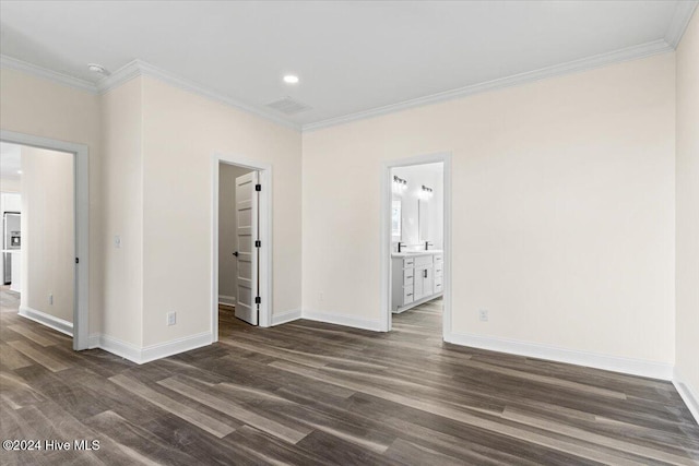 unfurnished room with ornamental molding, dark wood finished floors, and baseboards