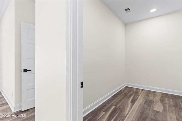 interior space featuring baseboards, visible vents, dark wood finished floors, and recessed lighting