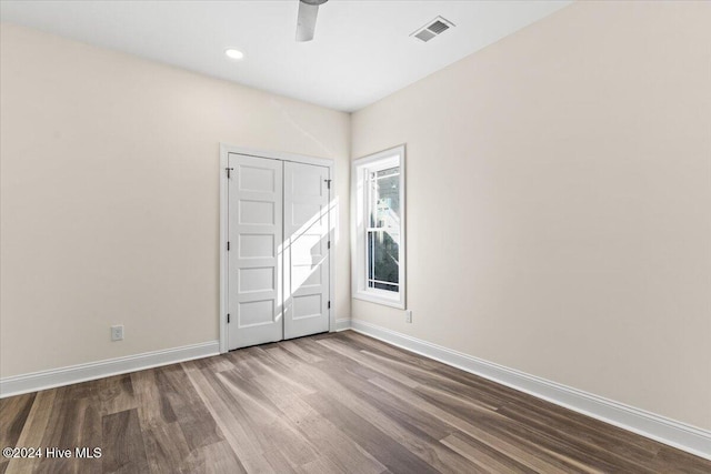 spare room featuring baseboards, visible vents, wood finished floors, and recessed lighting