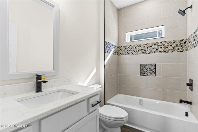 bathroom featuring vanity, toilet, and shower / bathtub combination