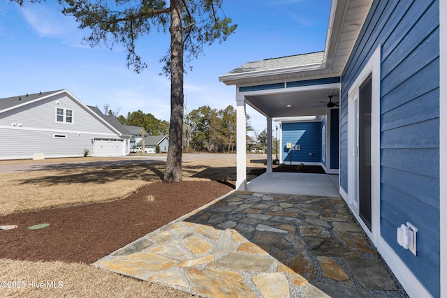 view of yard featuring a patio area and ceiling fan