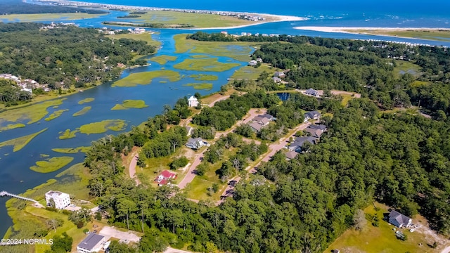 aerial view with a water view and a view of trees