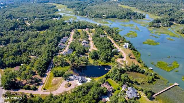 drone / aerial view featuring a water view and a view of trees