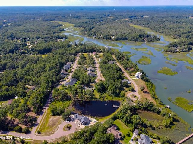 drone / aerial view with a water view and a wooded view