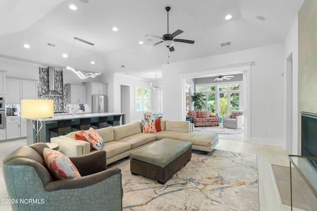 living room with light wood-type flooring and lofted ceiling