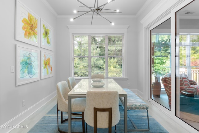 dining room featuring hardwood / wood-style floors, a notable chandelier, and ornamental molding