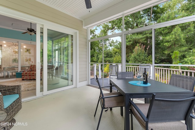 sunroom / solarium featuring ceiling fan