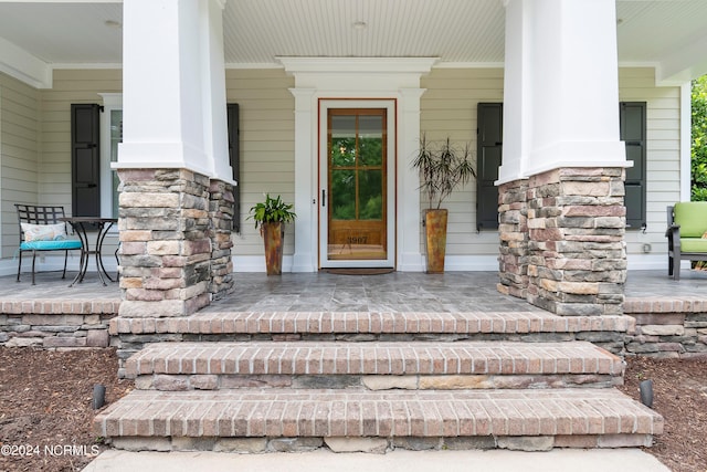 doorway to property with a porch