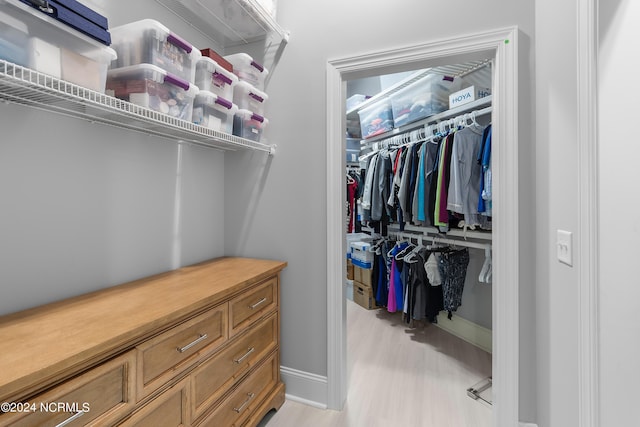 walk in closet featuring light hardwood / wood-style floors