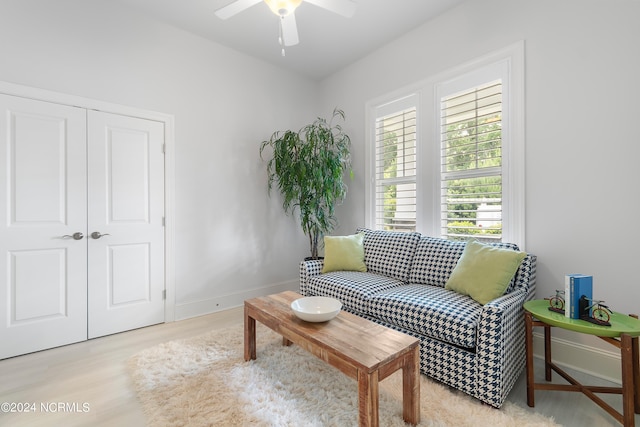 living area featuring ceiling fan and light wood-type flooring