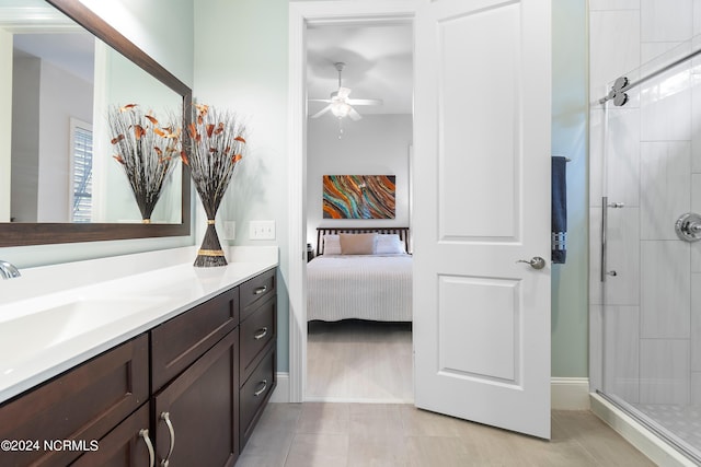 bathroom featuring ceiling fan, walk in shower, and vanity