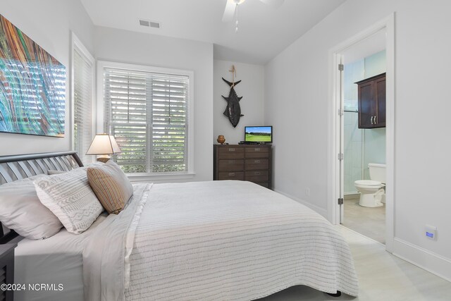 bedroom featuring ceiling fan and ensuite bathroom