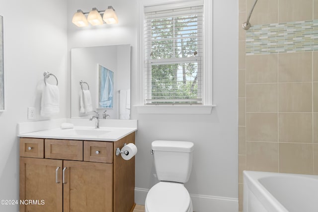 full bathroom featuring vanity, toilet, plenty of natural light, and tiled shower / bath combo