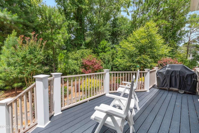 wooden terrace featuring a grill