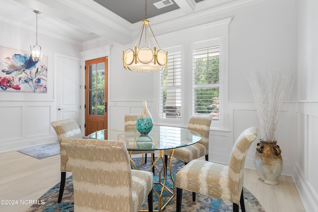 dining room with a chandelier, beamed ceiling, ornamental molding, and hardwood / wood-style floors