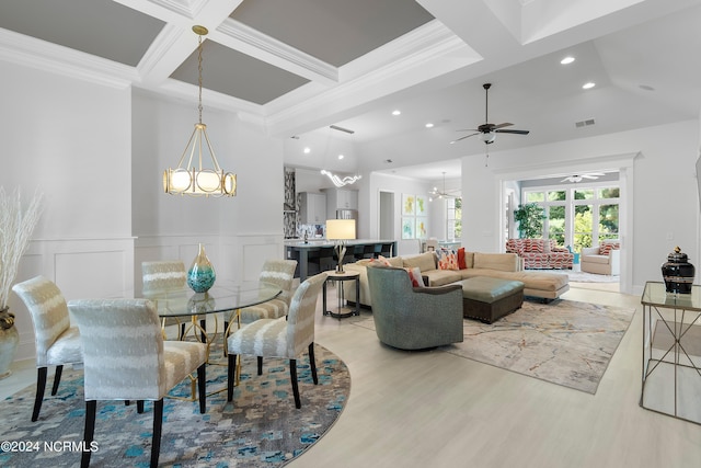 dining area featuring coffered ceiling, beamed ceiling, crown molding, ceiling fan with notable chandelier, and light wood-type flooring