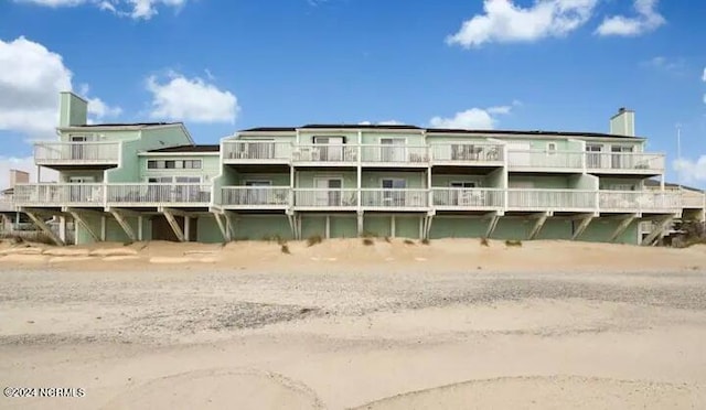 exterior space with a water view and a view of the beach