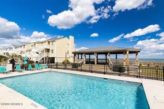 view of pool with a water view