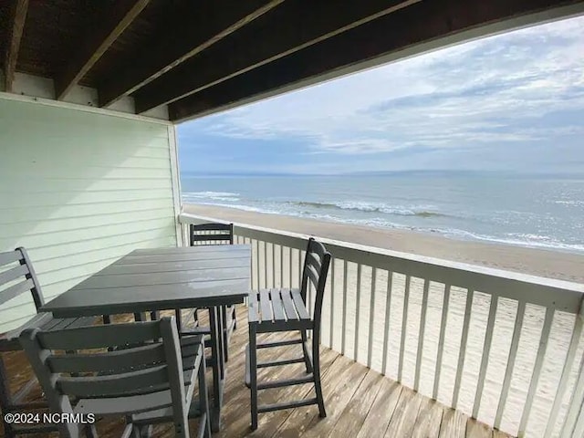 balcony with a view of the beach and a water view