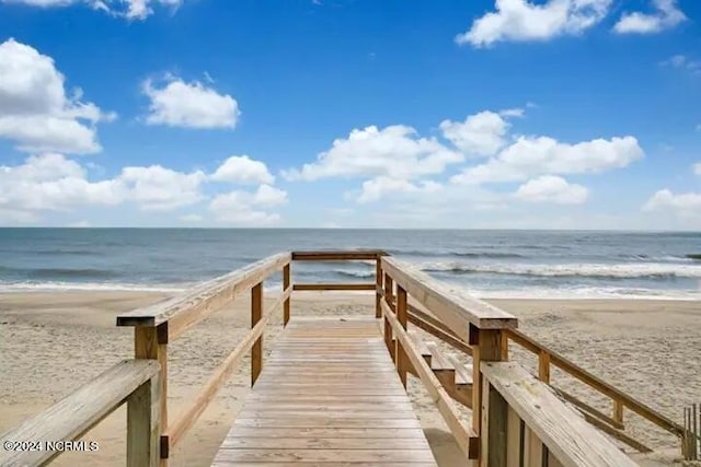 surrounding community featuring a view of the beach and a water view