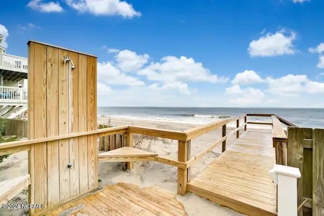 deck with a water view and a beach view