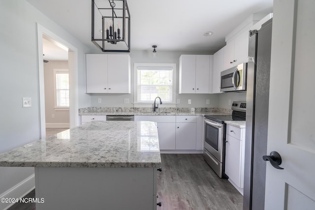 kitchen featuring white cabinetry, stainless steel appliances, and a kitchen island